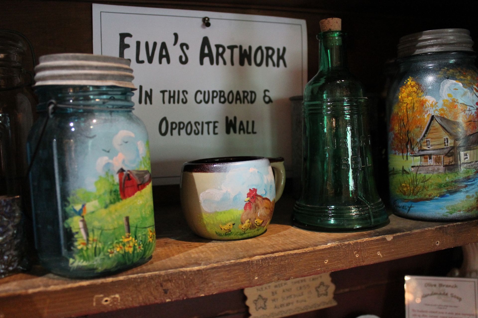 A sign that says elva 's artwork in this cupboard and opposite wall