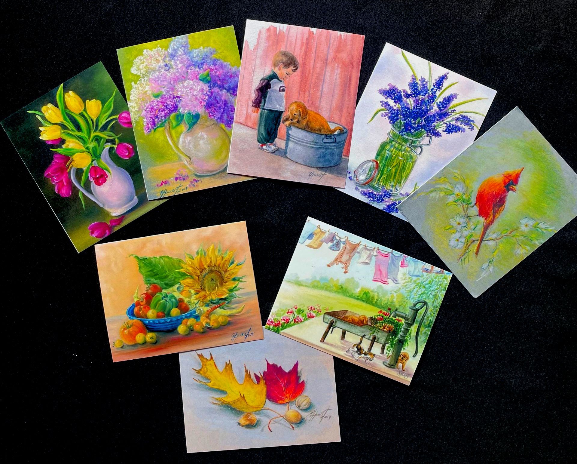 A bunch of cards with pictures of flowers and birds