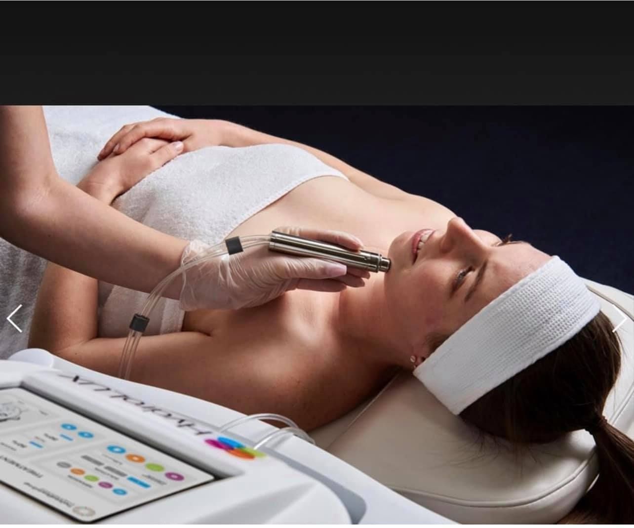 A Woman is Laying on a Bed Getting a Facial Treatment — Renew Laser Clinic in Taree, NSW