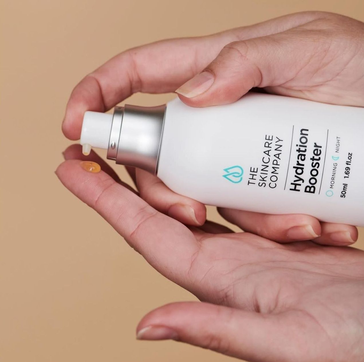 A Person is Holding a Bottle of the Skincare Company Hydration Booster — Renew Laser Clinic in Taree, NSW