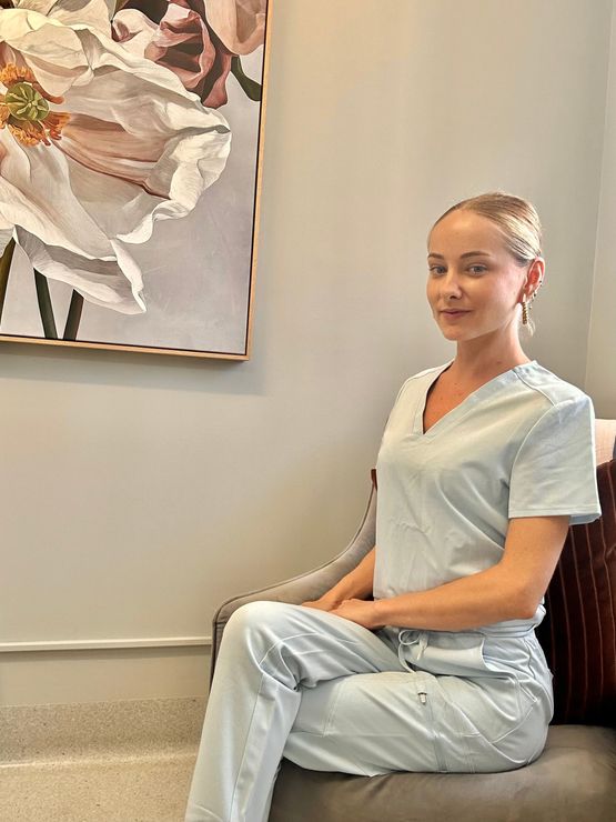A Woman is Getting Her Eyebrows Trimmed With a Scalpel — Renew Laser Clinic in Taree, NSW