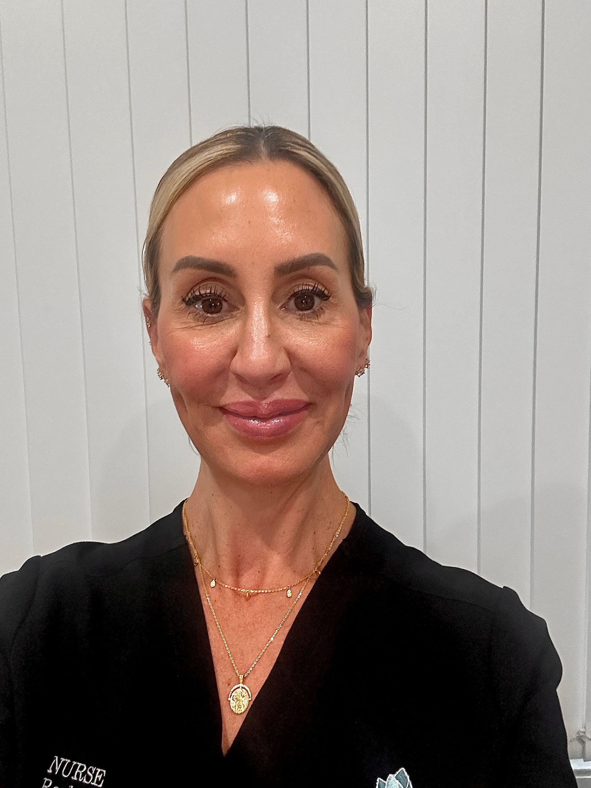 A Woman is Getting Her Eyebrows Trimmed With a Scalpel — Renew Laser Clinic in Taree, NSW