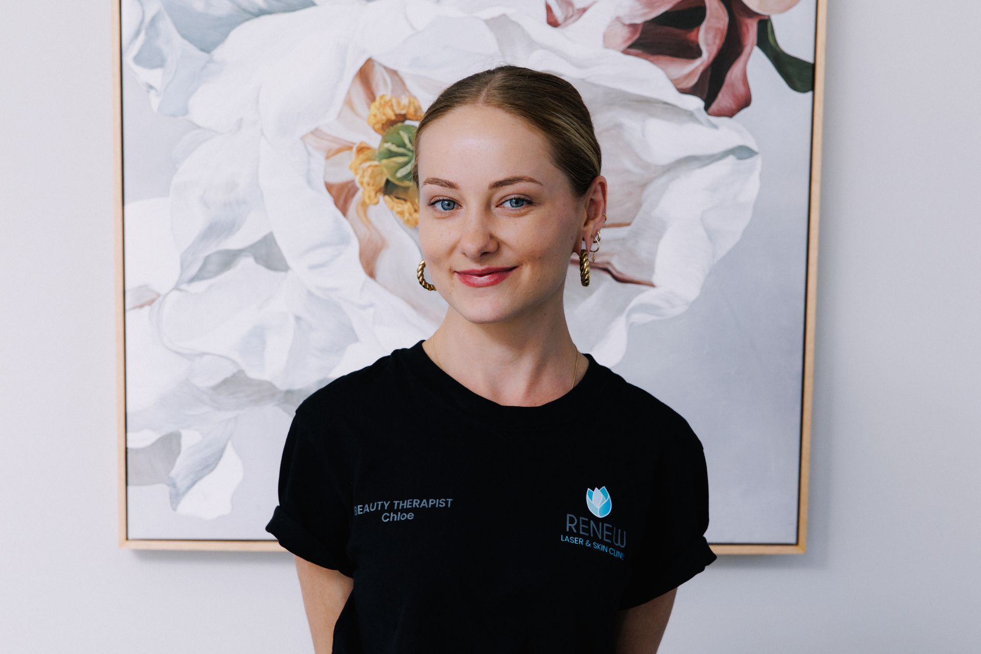 A Woman is Getting Her Eyebrows Trimmed With a Scalpel — Renew Laser Clinic in Taree, NSW