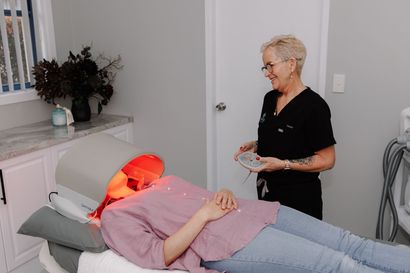 A Person is Laying on a Bed in a Room With a Machine — Renew Laser Clinic in Taree, NSW