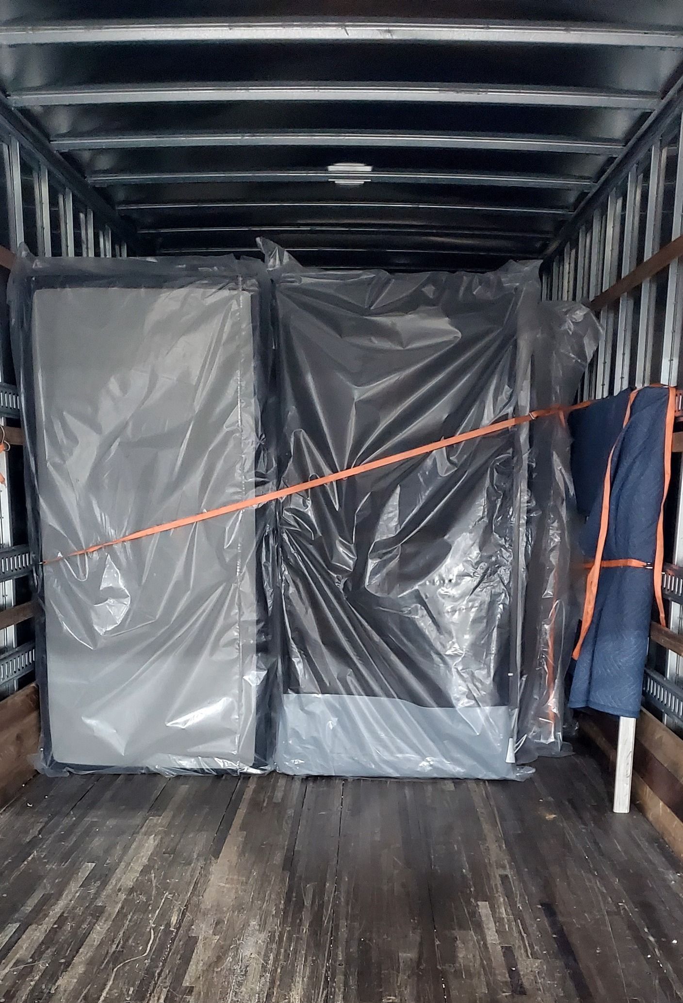A large piece of plastic is sitting in the back of a truck.