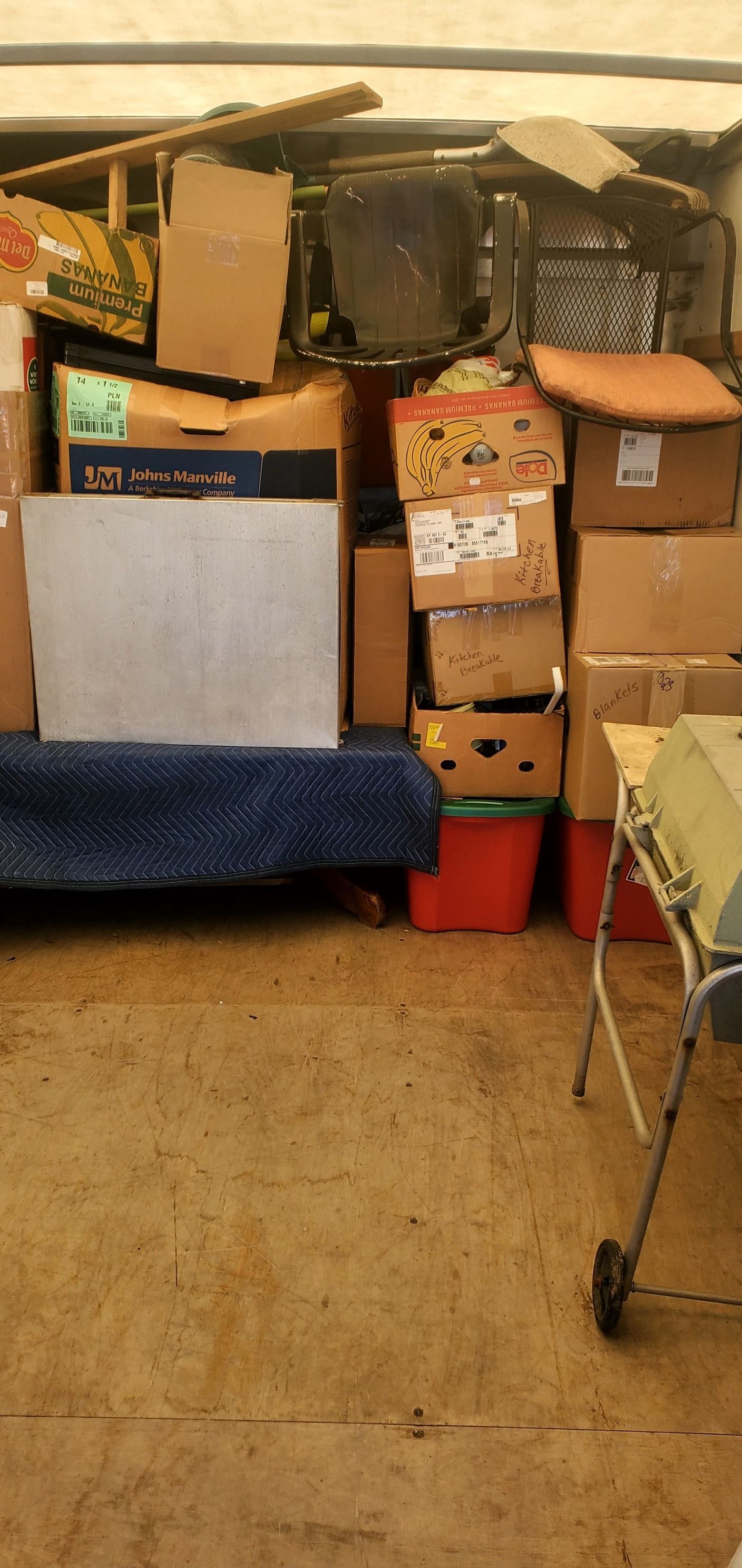 A room filled with lots of boxes and a chair.
