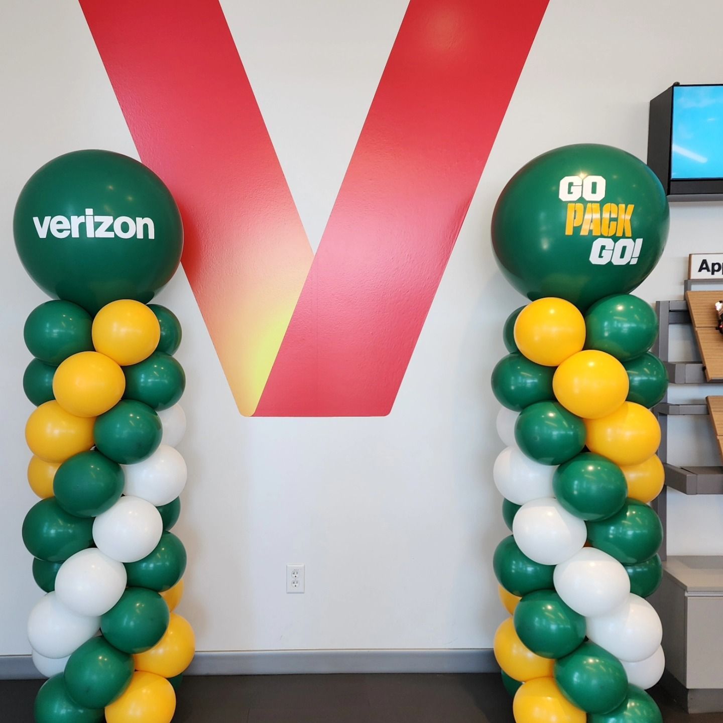 A thank you balloon is surrounded by blue and yellow balloons