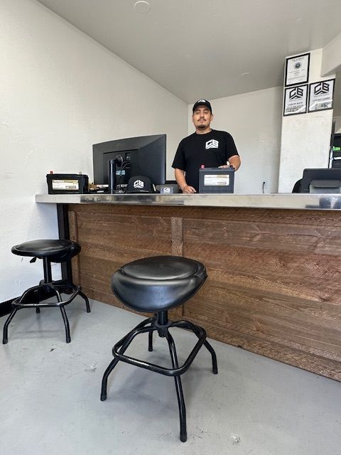 A man standing behind a counter with a computer on it