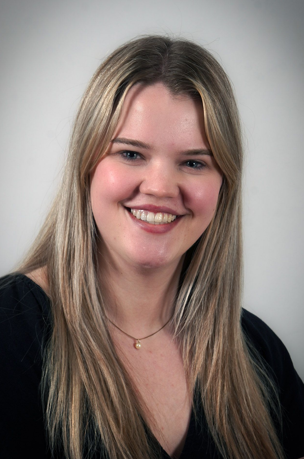 A silhouette of a man in a shirt and tie without a face.