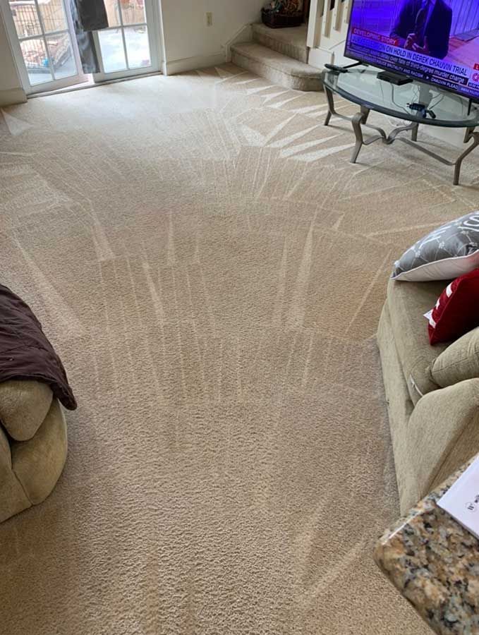 A living room with a couch , table , and television.