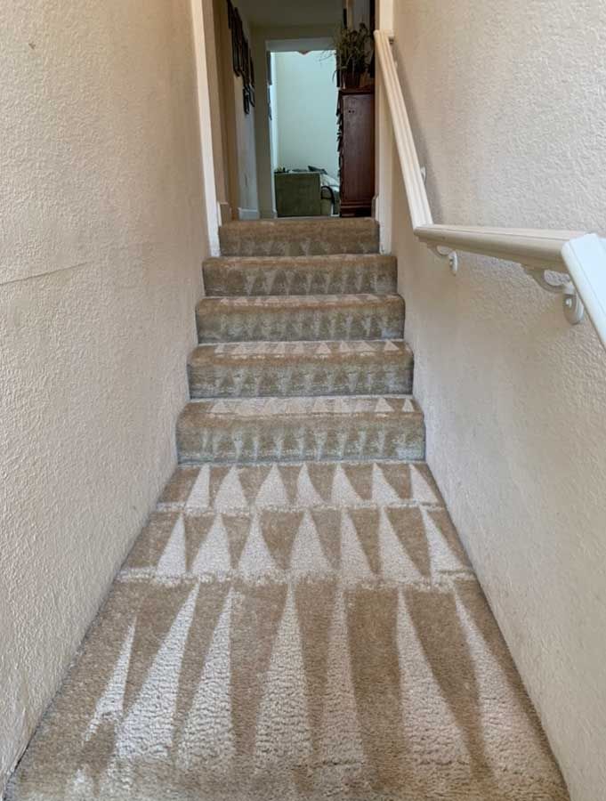 A set of stairs leading up to a living room in a house.