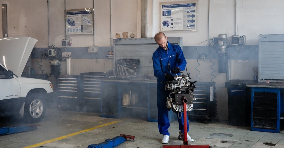 A man is working on a car engine in a garage.  | A 1 Brightside Auto