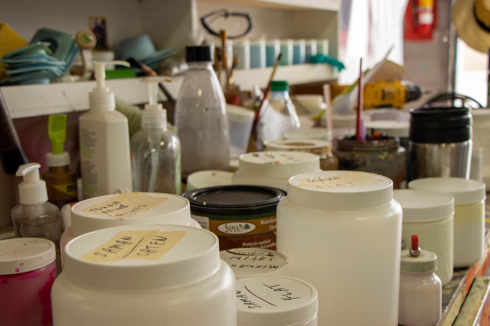 A bunch of jars and bottles are sitting on a table.