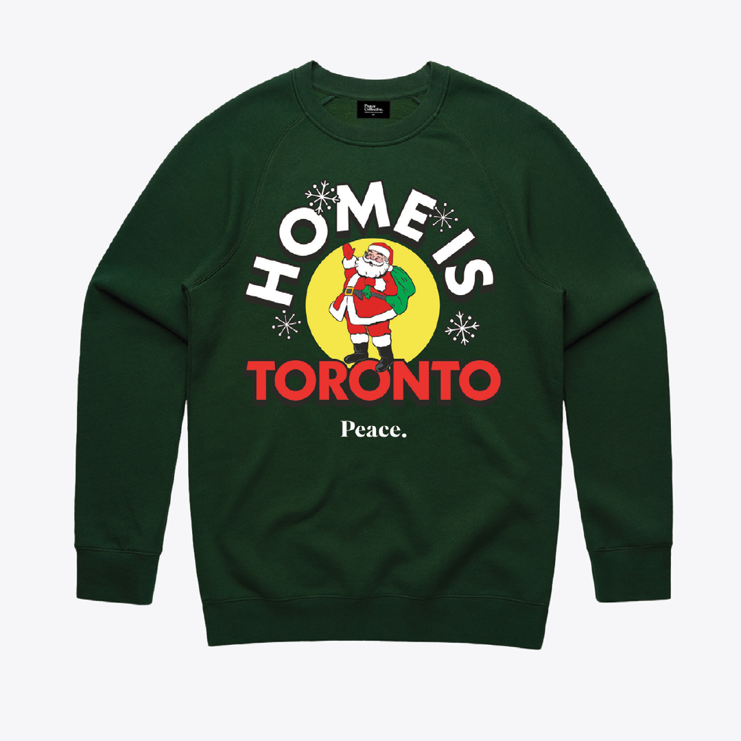 A green sweatshirt with a Christmas scene on it.