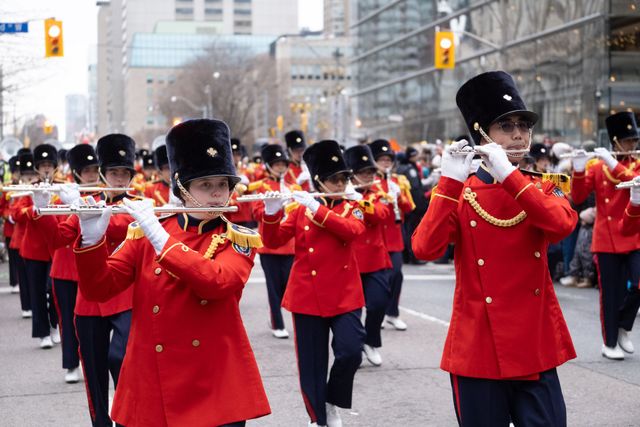 Spectacular Santa Claus parade float with elaborate decorations and costumed performers entertaining families