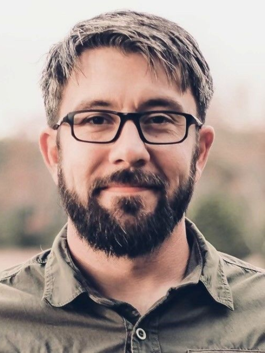 Brown wooden carved floral design with leaf and flower motifs.