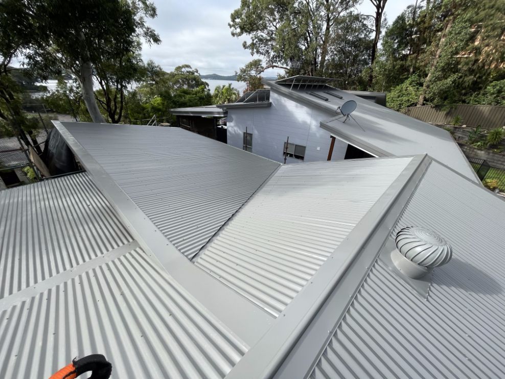 The Roof of a House Has a Satellite Dish on It — Platinum Pride Roofing In Bateau Bay, NSW