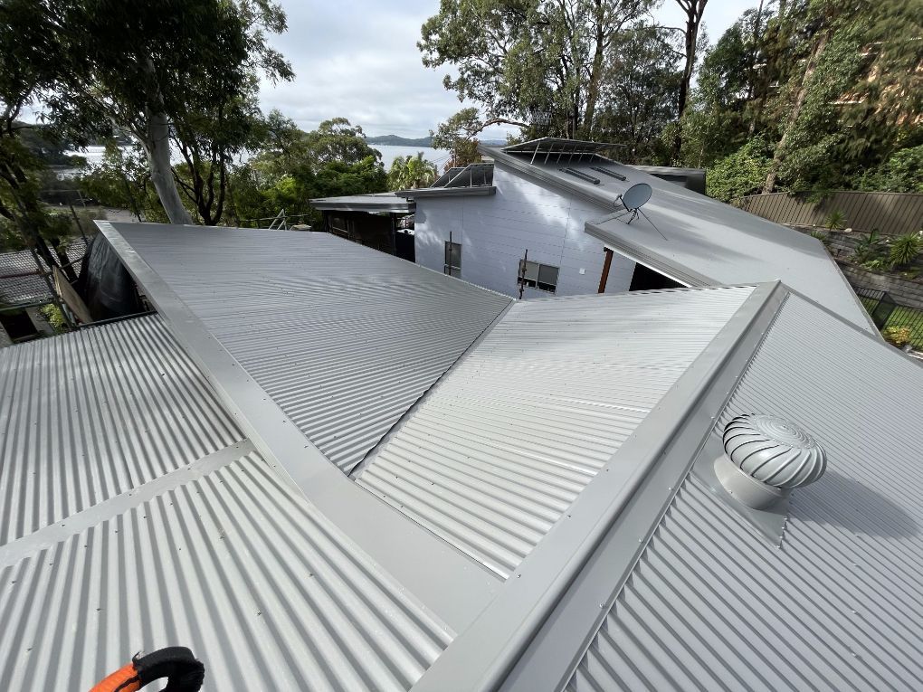 The Roof of a House With a Satellite Dish on It — Platinum Pride Roofing In Wyoming, NSW