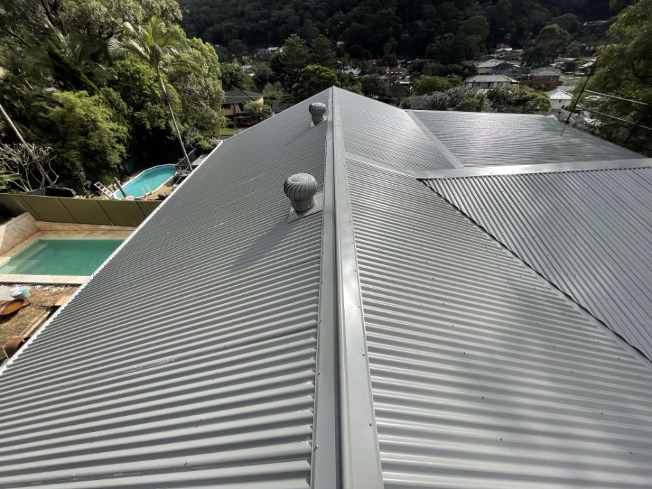 The Roof of a House With a Pool in the Background — Platinum Pride Roofing In Wyoming, NSW