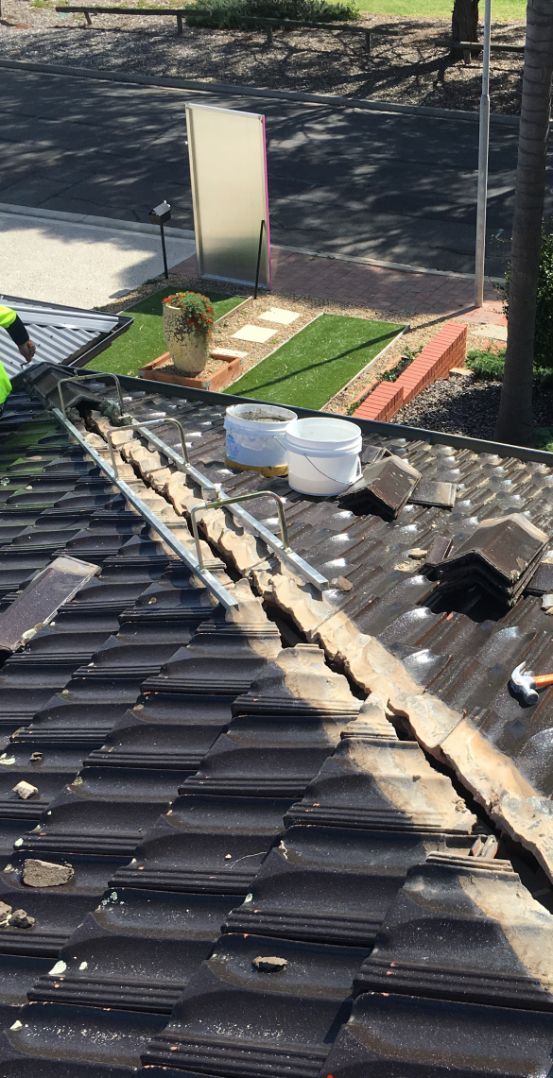 A Roof With a Lot of Tiles on It is Being Repaired — Platinum Pride Roofing In Bateau Bay, NSW