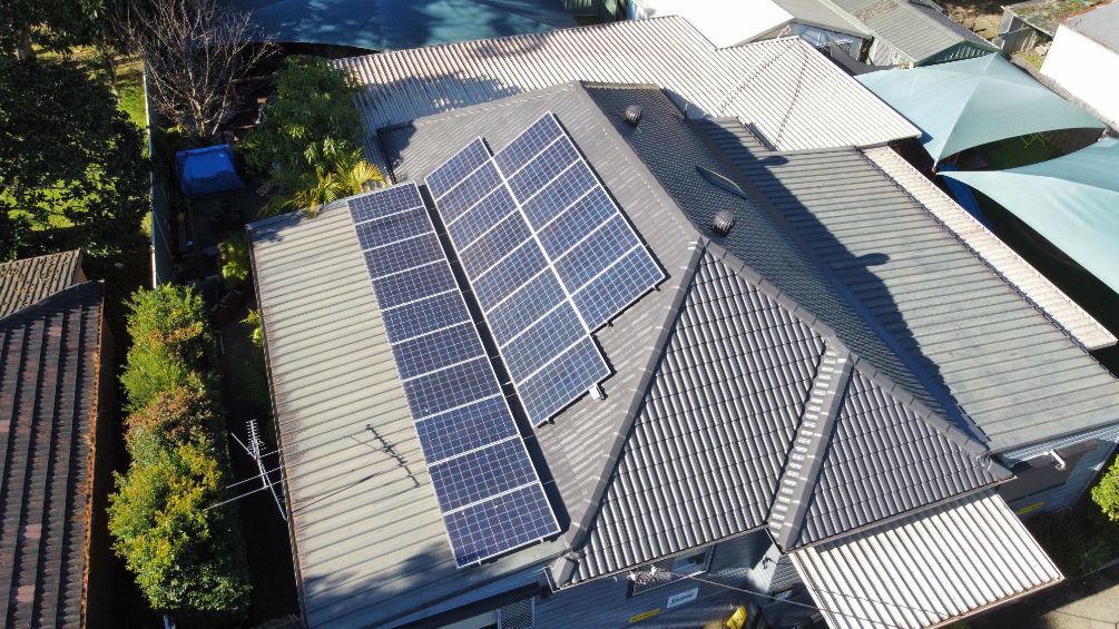 An Aerial View of a House With Solar Panels on the Roof — Platinum Pride Roofing In Wyoming, NSW