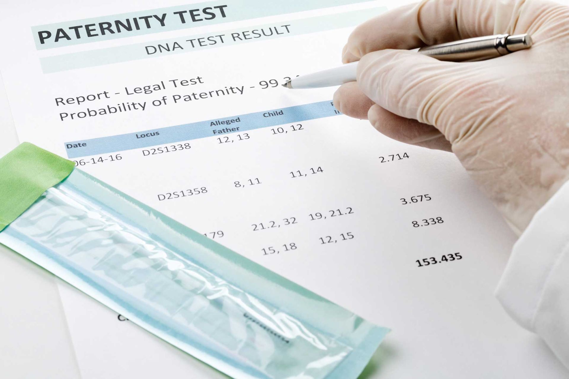 A gloved hand pointing to a paternity test result document with a swab.