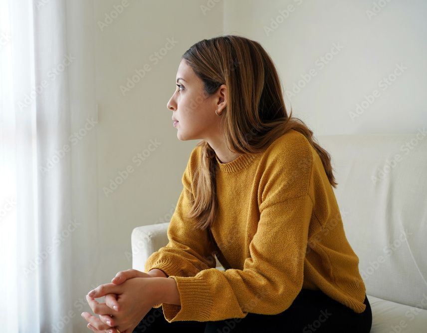 A separation agreement document, pen, glasses, ink stamp, and books on a wooden desk.