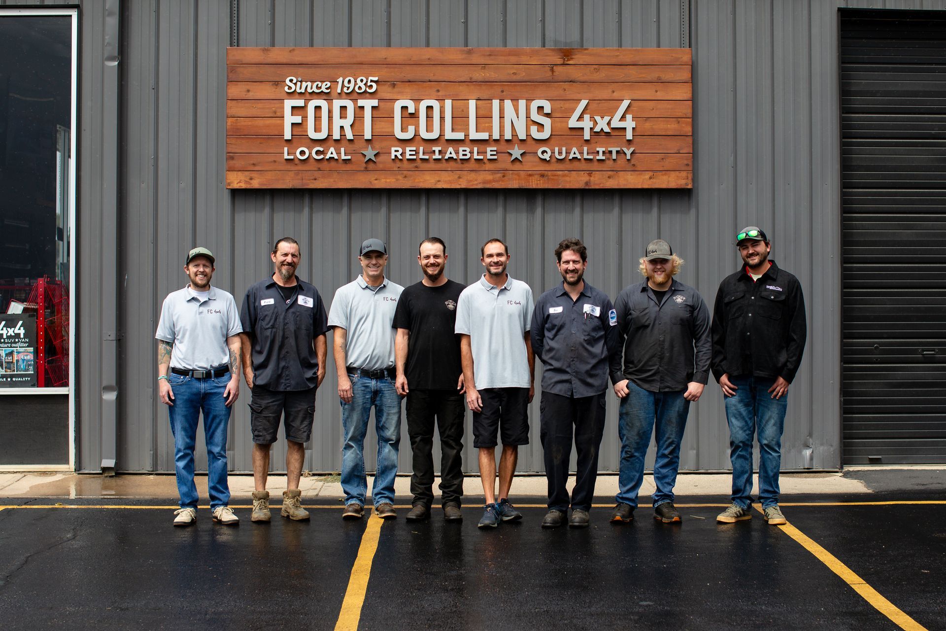 Group of nine people in front of a brown wooden sign | Fort Collins 4x4