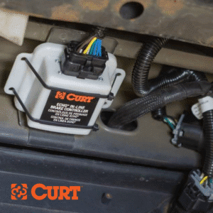 White CURT trailer brake controller mounted under a vehicle | Fort Collins 4x4