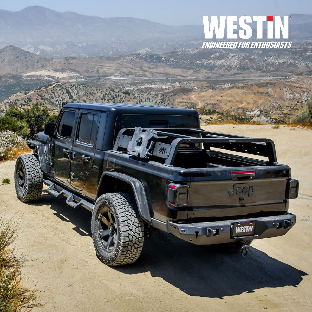 Black Jeep Gladiator with Westin rack on a dirt road in a mountainous | Fort Collins 4x4