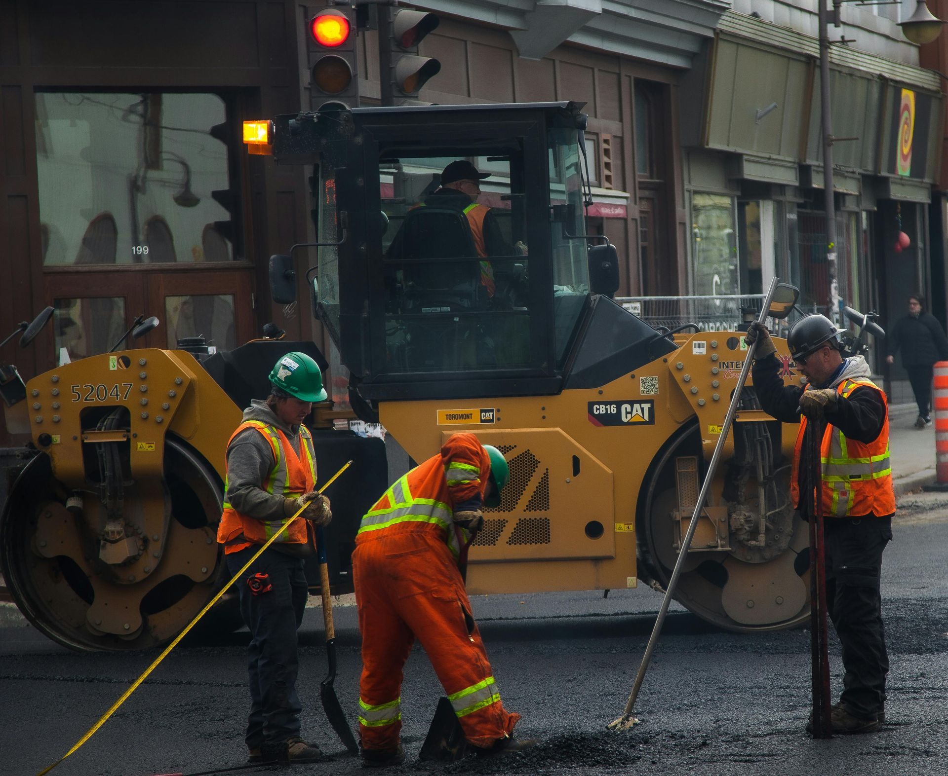 A group of construction workers are working on a road