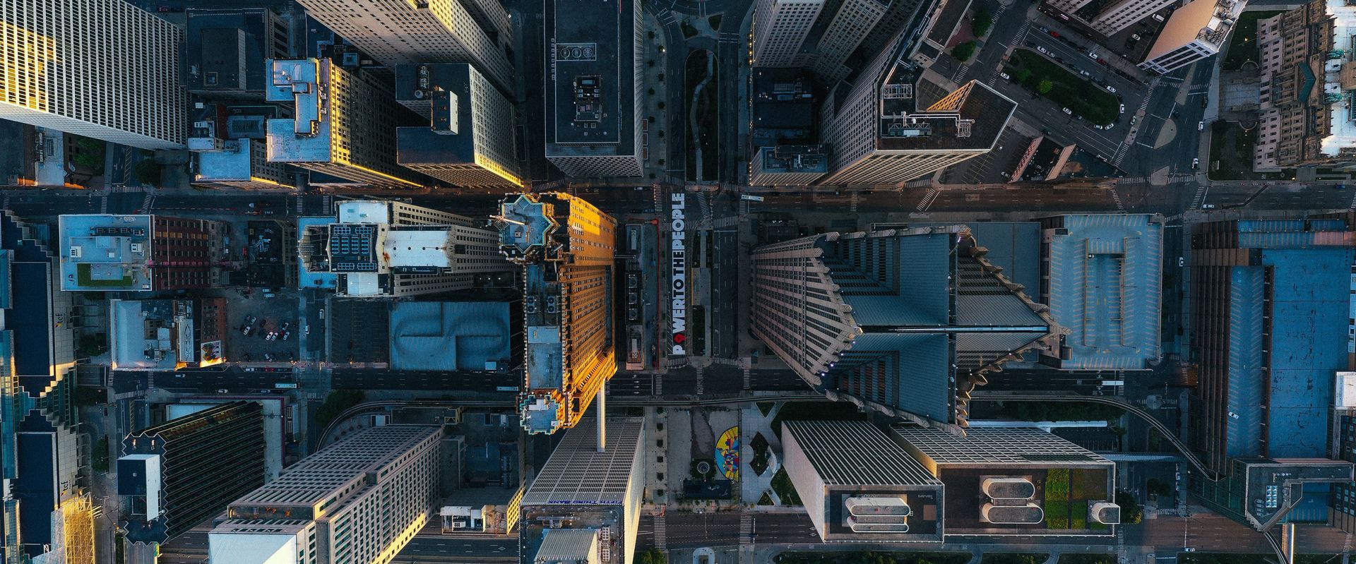 An aerial view of a city at night with lots of buildings and streets.