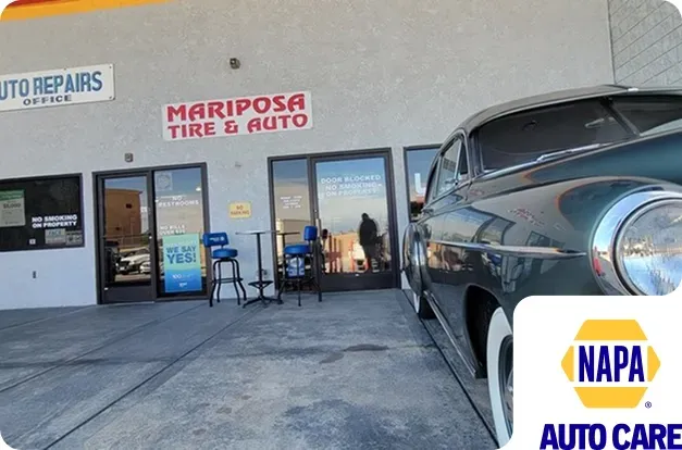 Classic car parked in front of our parking lot in Hesperia, CA with NAPA Auto Care Logo | Mariposa Tire & Auto