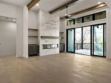 A living room with a fireplace and sliding glass doors.