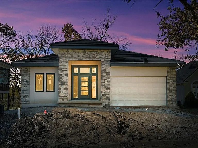 A house with a purple sky in the background