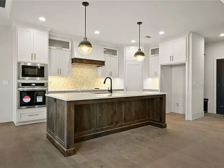 There is a large island in the middle of the kitchen.