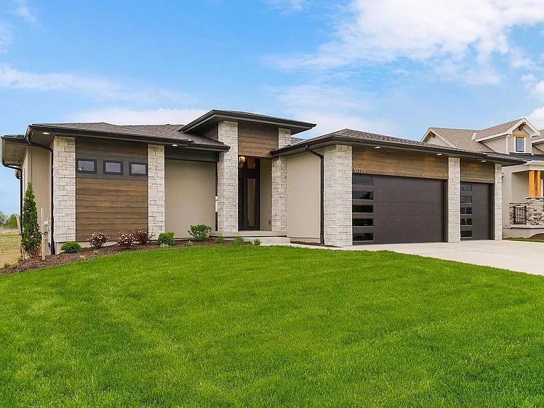 A large house with a large lawn in front of it.