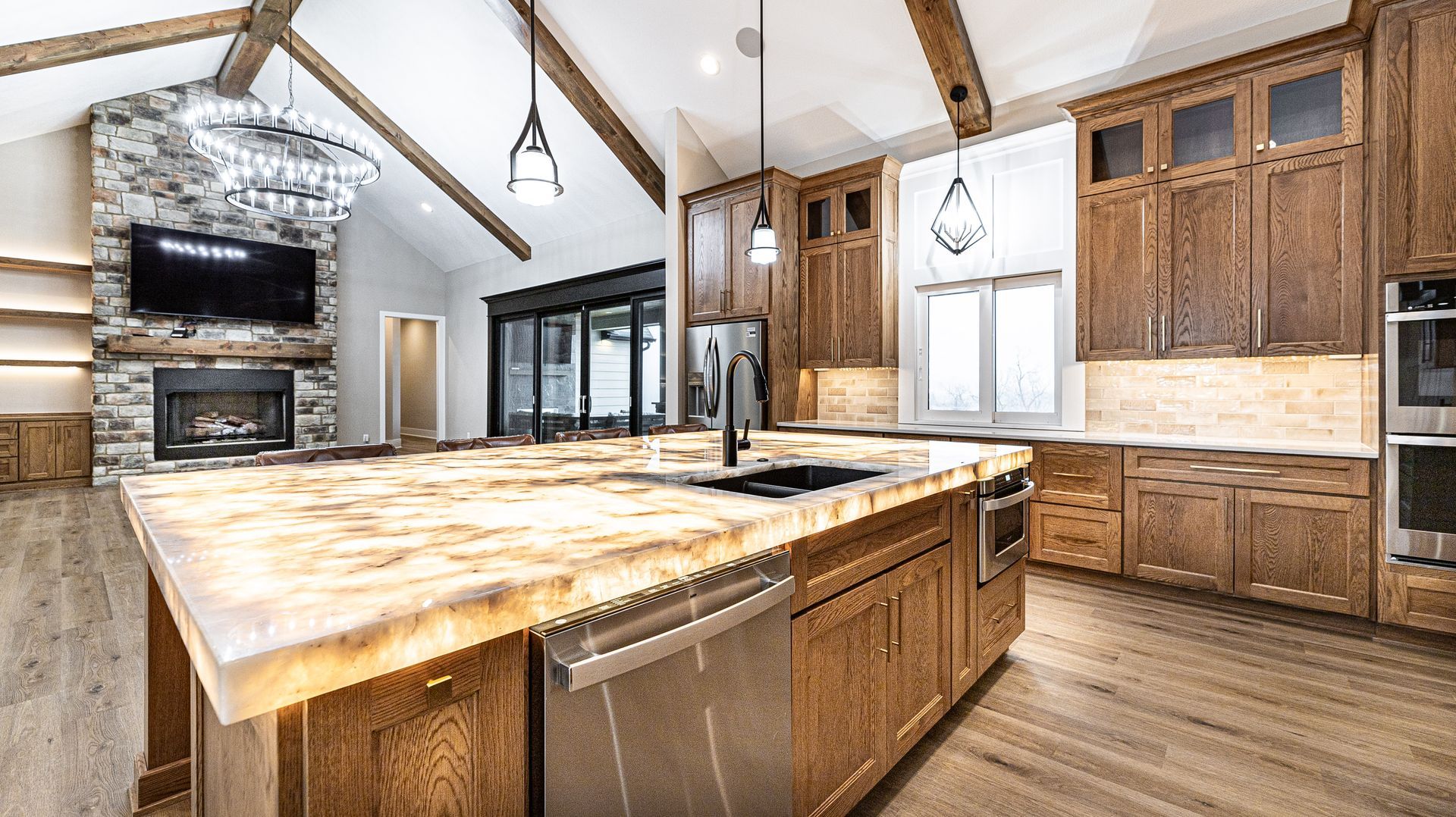 A kitchen with a large island and stainless steel appliances.