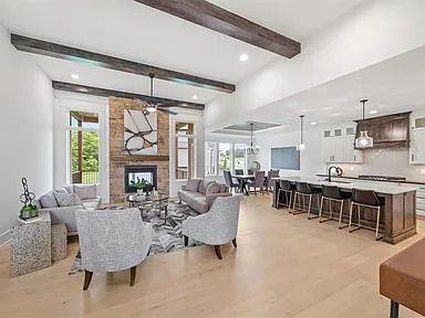 A living room with a couch , chairs , and a fireplace.