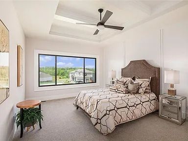 An empty living room with a large window and sliding glass doors.