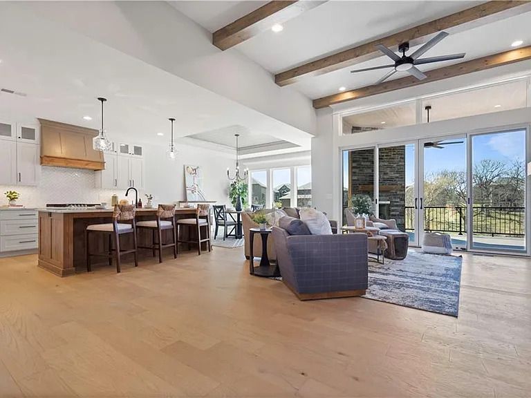 A living room filled with furniture and a ceiling fan.