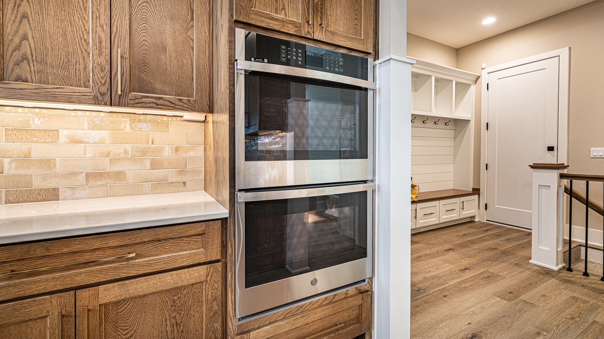 A kitchen with stainless steel appliances and wooden cabinets.