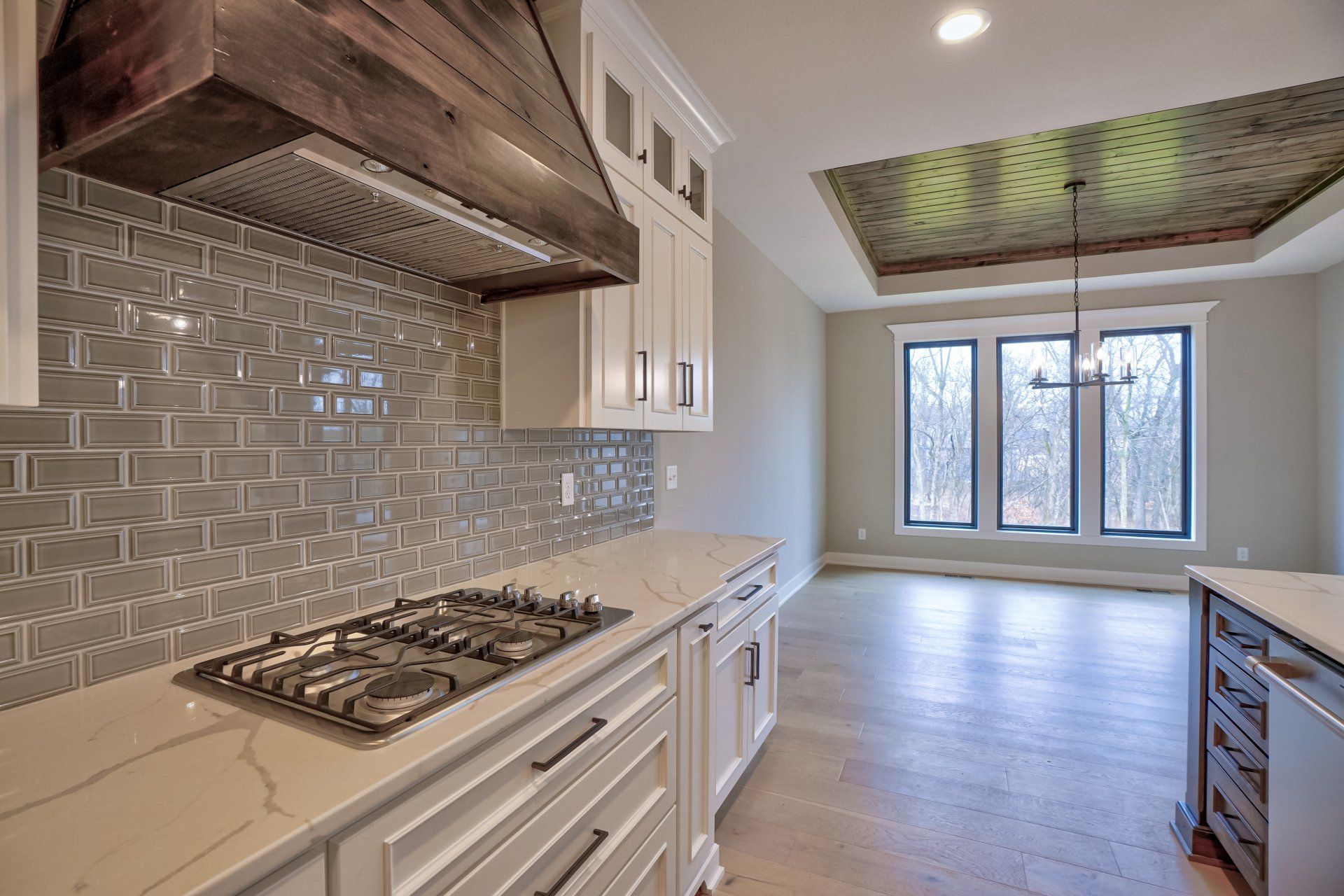 A kitchen with a stove top oven and a hood.