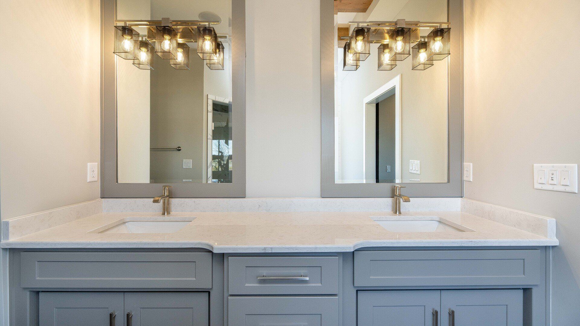 A bathroom with two sinks and two mirrors.