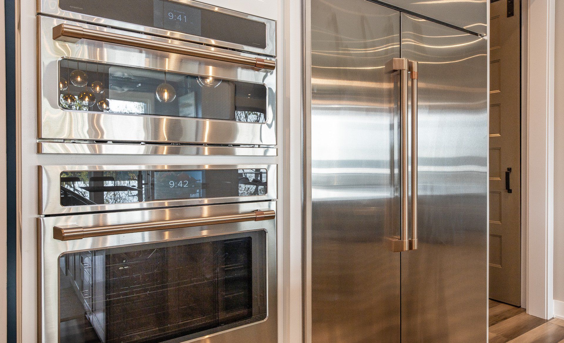 A kitchen with stainless steel appliances and a refrigerator.