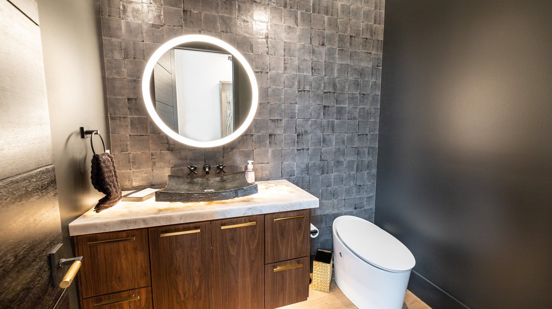 A bathroom with a sink , toilet and mirror.