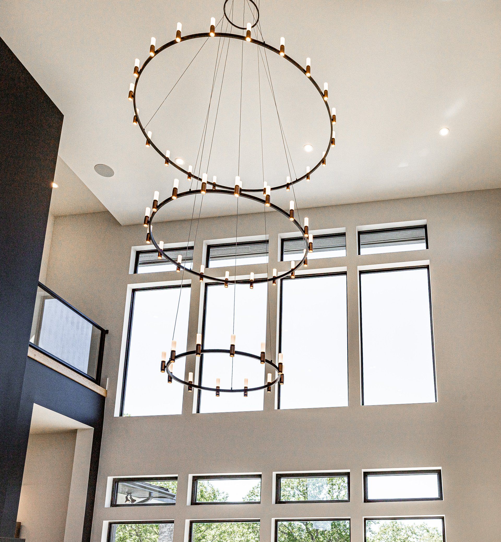 A large room with lots of windows and a chandelier hanging from the ceiling