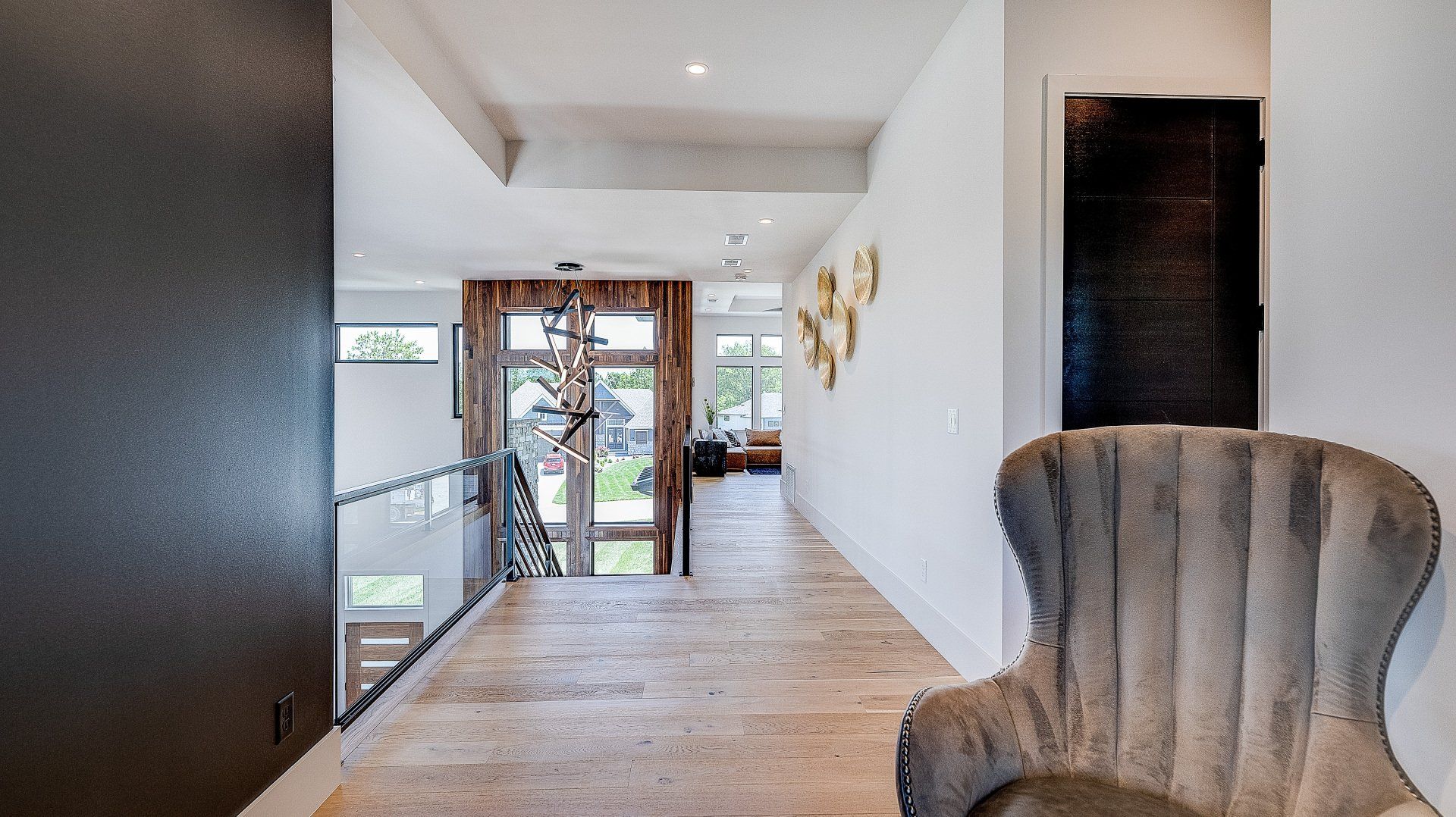 A chair is sitting in a hallway next to a door.