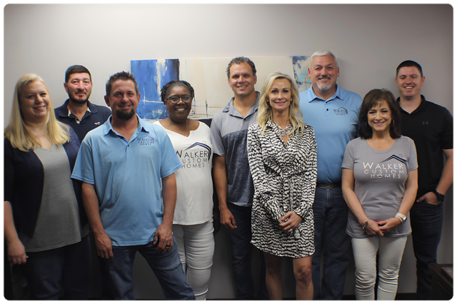 A group of people are posing for a picture in a room.