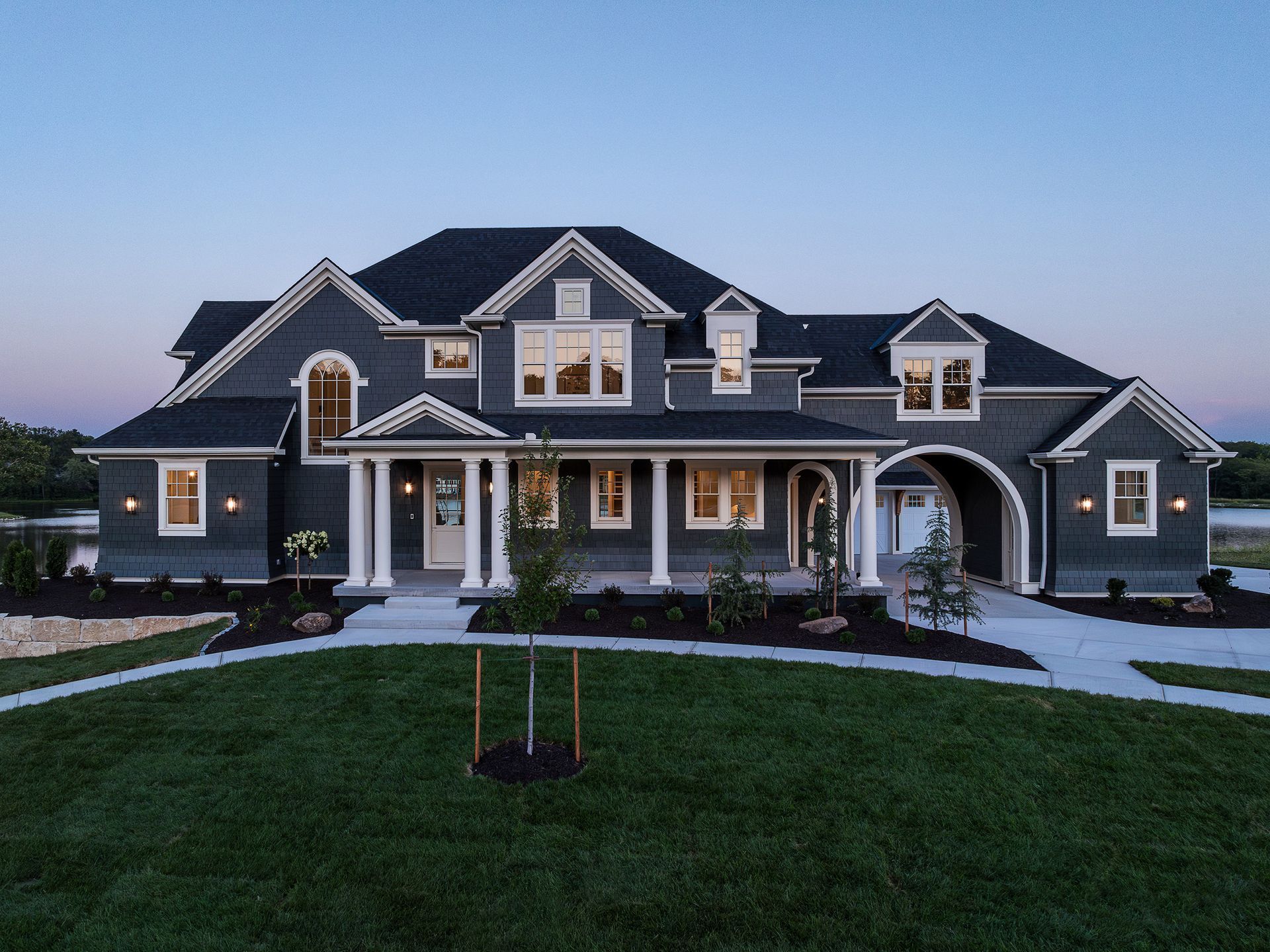 A large house with a lot of windows and a tree in front of it